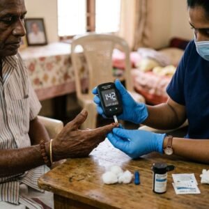 Blood sugar monitoring during home nursing care for diabetic patients as a nurse checks glucose levels of an elderly patient at home